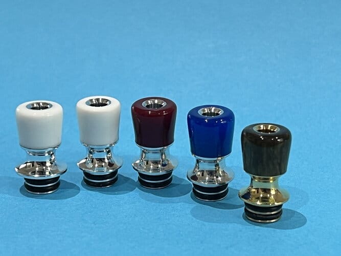 A cutaway diagram showing the internal chimney contours of vape mouthpieces, contrasting a straight-walled design with a conical or funnel-shaped interior to illustrate benefits like reduced turbulence and condensation.