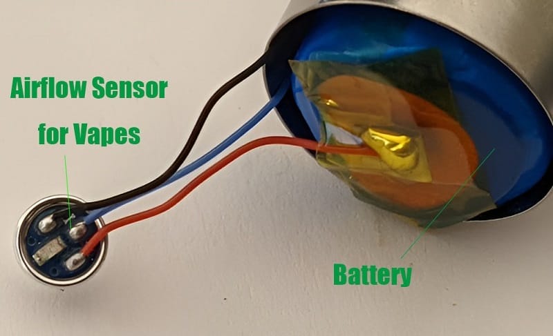 A technical diagram or illustration depicting e-liquid condensation or seepage reaching and potentially fouling an internal pneumatic draw sensor in a vape, highlighting reliability vulnerabilities.