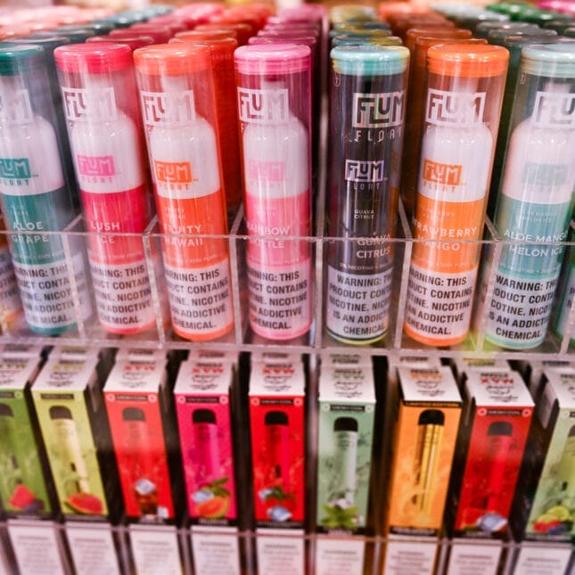 A vibrant display of various disposable vape flavours, possibly with illustrations of fruits, desserts, or beverage themes, representing the wide selection from vape brands.