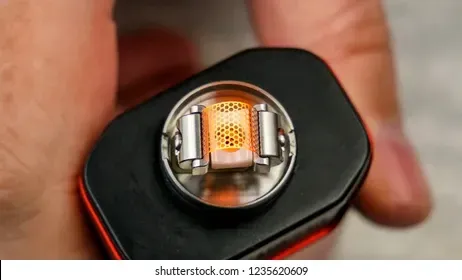 A magnified close-up image of a modern mesh atomizer coil, showing its intricate structure designed for vaporizing e-liquid.